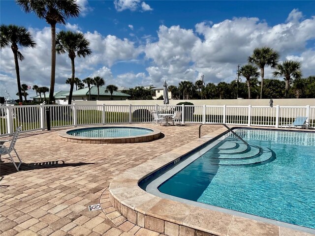 2100 N Peninsula Ave Unit 2160, New Smyrna Beach, FL 32169 - community pool with fence and a patio area