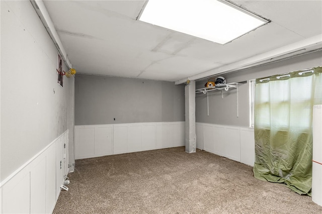 2576 Sunset Dr, New Smyrna Beach, FL 32168 - basement with carpet and a wainscoted wall