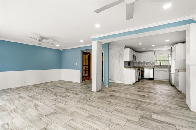 2576 Sunset Dr, New Smyrna Beach, FL 32168 - unfurnished living room with a ceiling fan, recessed lighting, wainscoting, and crown molding