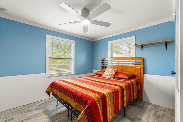 2576 Sunset Dr, New Smyrna Beach, FL 32168 - bedroom with ornamental molding, wainscoting, wood finished floors, ceiling fan, and wooden walls