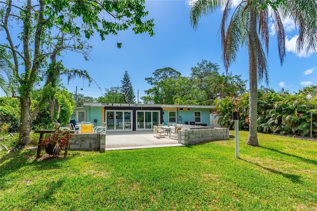 2576 Sunset Dr, New Smyrna Beach, FL 32168 - rear view of property featuring a lawn and a patio area