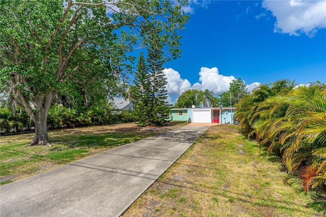 2576 Sunset Dr, New Smyrna Beach, FL 32168 - view of front of property featuring driveway and a front yard