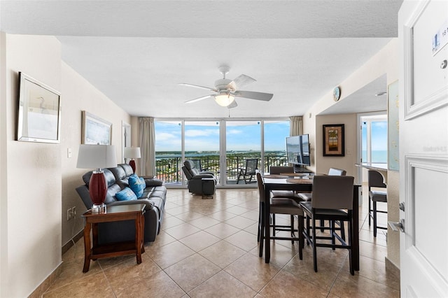 2625 S Atlantic Ave Unit 18Nw, Daytona Beach, FL 32118 - dining room with a ceiling fan, a wall of windows, tile patterned flooring, and baseboards