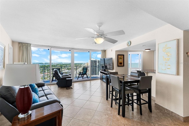 2625 S Atlantic Ave Unit 18Nw, Daytona Beach, FL 32118 - dining space with plenty of natural light, light tile patterned floors, ceiling fan, expansive windows, and a textured ceiling