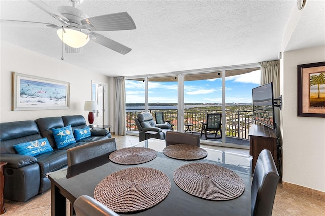 2625 S Atlantic Ave Unit 18Nw, Daytona Beach, FL 32118 - dining area featuring a wall of windows, light tile patterned floors, a textured ceiling, baseboards, and a ceiling fan