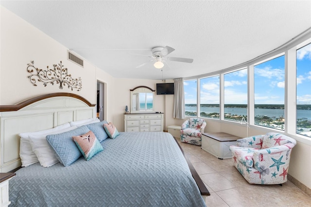2625 S Atlantic Ave Unit 18Nw, Daytona Beach, FL 32118 - bedroom featuring light tile patterned floors, a textured ceiling, and a ceiling fan