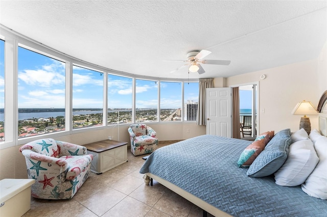 2625 S Atlantic Ave Unit 18Nw, Daytona Beach, FL 32118 - bedroom featuring a water view, light tile patterned flooring, ceiling fan, and a textured ceiling