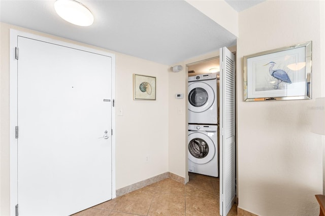 2625 S Atlantic Ave Unit 18Nw, Daytona Beach, FL 32118 - laundry area with stacked washer and clothes dryer, light tile patterned floors, and baseboards