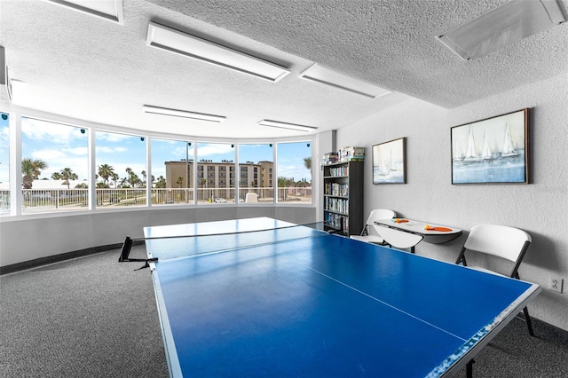 2625 S Atlantic Ave Unit 18Nw, Daytona Beach, FL 32118 - game room featuring a textured ceiling, a textured wall, baseboards, and carpet flooring