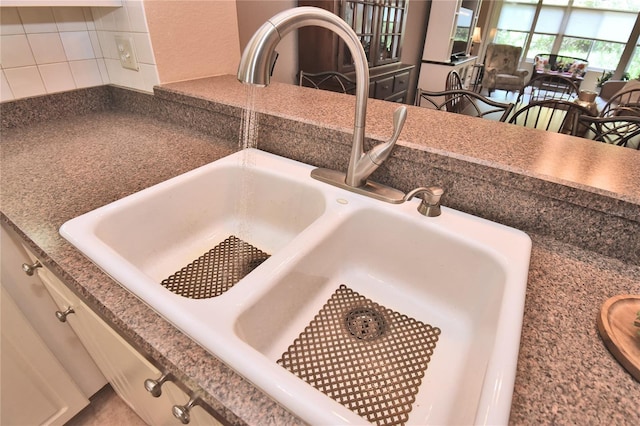 1442 Carlow Cir, Ormond Beach, FL 32174 - detailed view of a sink, backsplash, and dark countertops