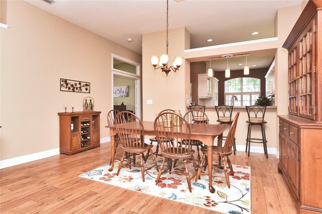 1442 Carlow Cir, Ormond Beach, FL 32174 - dining space with light wood-style floors, a chandelier, and baseboards
