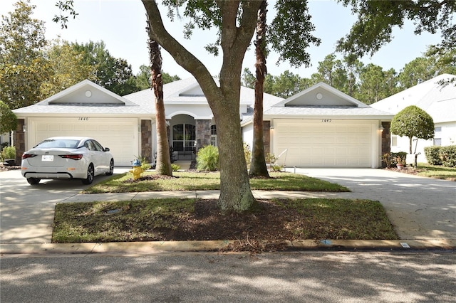 1442 Carlow Cir, Ormond Beach, FL 32174 - ranch-style home featuring an attached garage, driveway, and stone siding