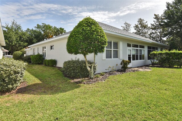 1442 Carlow Cir, Ormond Beach, FL 32174 - view of property exterior with stucco siding and a yard