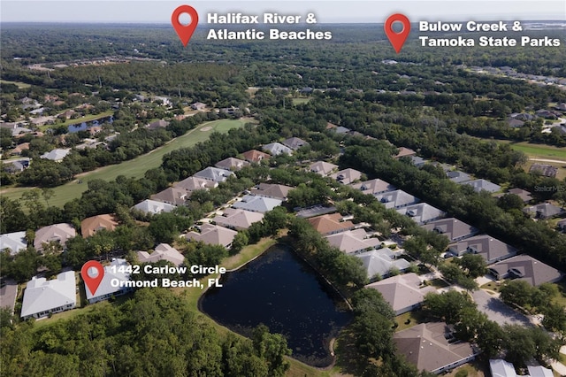 1442 Carlow Cir, Ormond Beach, FL 32174 - aerial view of property's location with nearby suburban area, a large body of water, a forest, and a golf course
