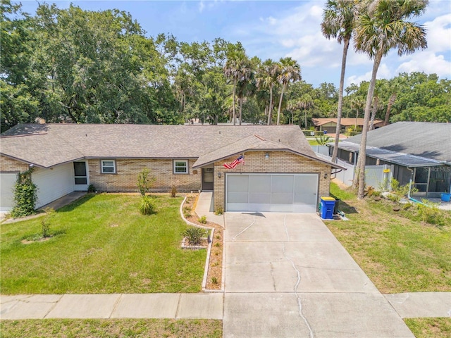 1205 Bond St, Edgewater, FL 32132 - ranch-style house with brick siding, a front lawn, an attached garage, concrete driveway, and roof with shingles