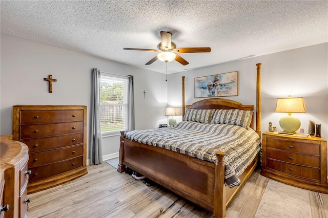 1205 Bond St, Edgewater, FL 32132 - bedroom with light wood finished floors, a textured ceiling, a ceiling fan, and baseboards