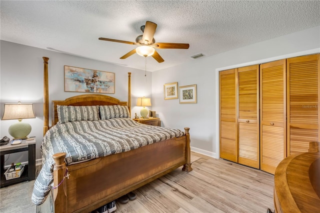 1205 Bond St, Edgewater, FL 32132 - bedroom featuring a closet, a textured ceiling, light wood finished floors, ceiling fan, and baseboards