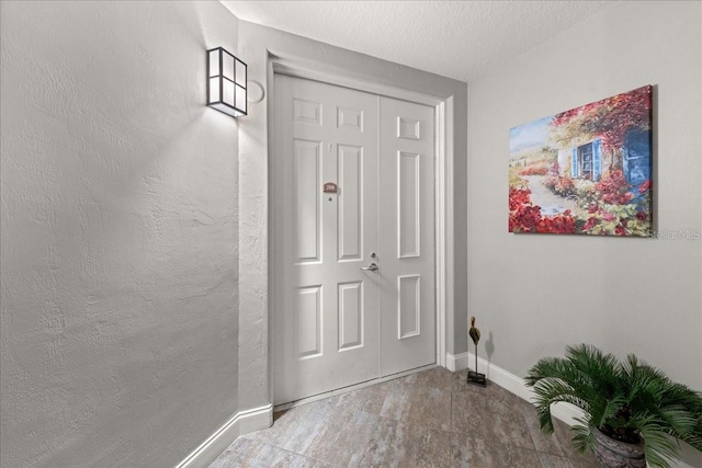3245 S Atlantic Ave Unit 208, Daytona Beach, FL 32118 - entryway featuring baseboards and a textured ceiling
