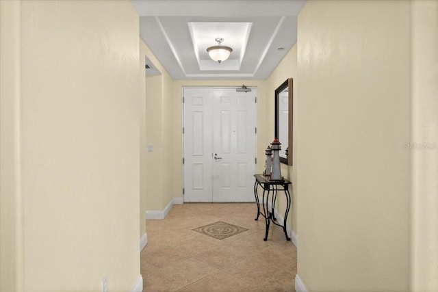 3245 S Atlantic Ave Unit 208, Daytona Beach, FL 32118 - doorway to outside featuring a tray ceiling, baseboards, and light tile patterned flooring