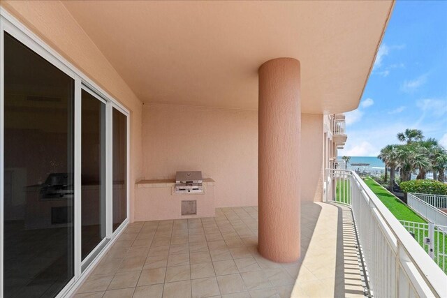 3245 S Atlantic Ave Unit 208, Daytona Beach, FL 32118 - balcony featuring a water view, an outdoor kitchen, and area for grilling
