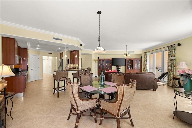 3245 S Atlantic Ave Unit 208, Daytona Beach, FL 32118 - dining space featuring light tile patterned flooring, crown molding, and a chandelier