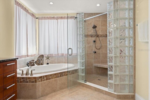 3245 S Atlantic Ave Unit 208, Daytona Beach, FL 32118 - full bathroom featuring a shower stall, a garden tub, and tile patterned flooring