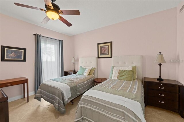 3245 S Atlantic Ave Unit 208, Daytona Beach, FL 32118 - bedroom featuring ceiling fan, light tile patterned flooring, and baseboards