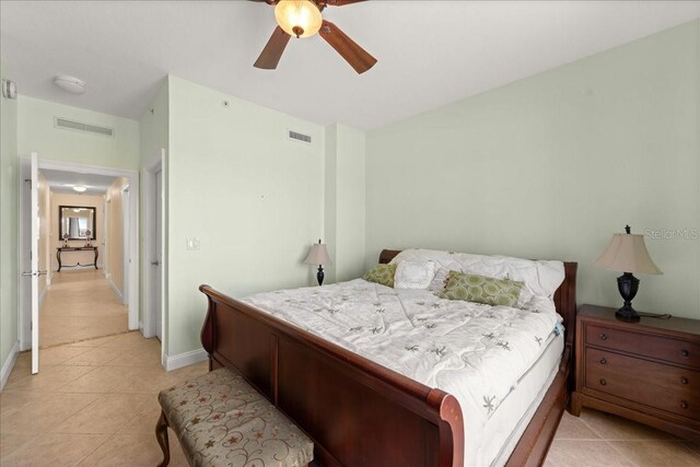 3245 S Atlantic Ave Unit 208, Daytona Beach, FL 32118 - bedroom featuring light tile patterned floors, baseboards, and a ceiling fan
