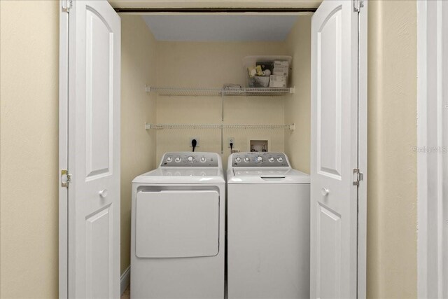 3245 S Atlantic Ave Unit 208, Daytona Beach, FL 32118 - clothes washing area with washer and clothes dryer