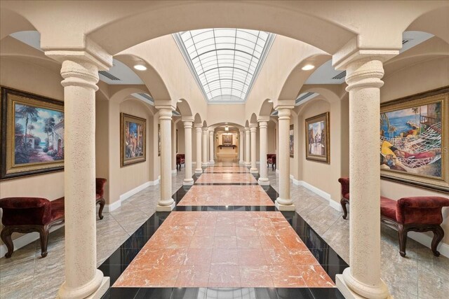 3245 S Atlantic Ave Unit 208, Daytona Beach, FL 32118 - hall featuring decorative columns, inlaid floor details, baseboards, arched walkways, and recessed lighting