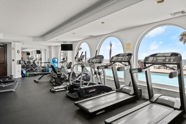 3245 S Atlantic Ave Unit 208, Daytona Beach, FL 32118 - exercise room with ornamental molding, a textured ceiling, and recessed lighting