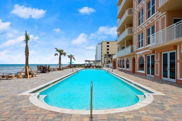 3245 S Atlantic Ave Unit 208, Daytona Beach, FL 32118 - community pool featuring a water view and a patio