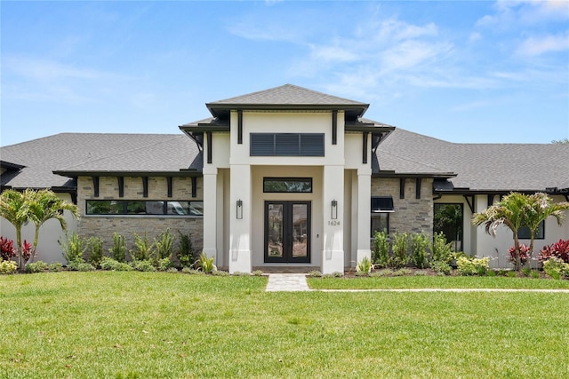 1624 Turnbull Crossings Dr, New Smyrna Beach, FL 32168 - prairie-style house featuring french doors, a front yard, stone siding, stucco siding, and roof with shingles