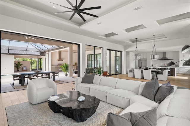 1624 Turnbull Crossings Dr, New Smyrna Beach, FL 32168 - living room with a tray ceiling and light wood-style floors