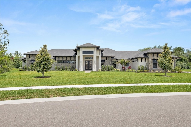1624 Turnbull Crossings Dr, New Smyrna Beach, FL 32168 - prairie-style home with french doors, a front lawn, and stucco siding