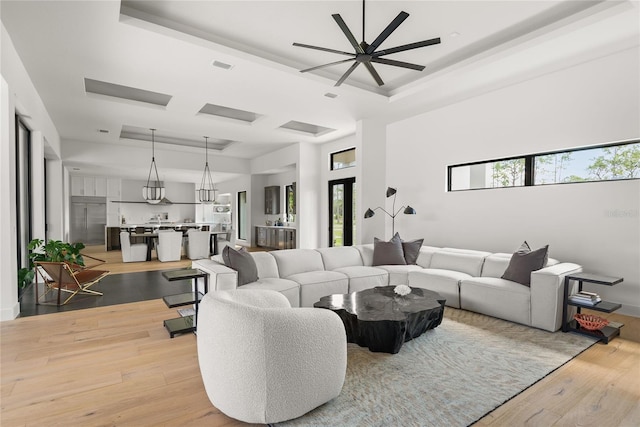 1624 Turnbull Crossings Dr, New Smyrna Beach, FL 32168 - living area featuring a tray ceiling, ceiling fan, and light wood-type flooring