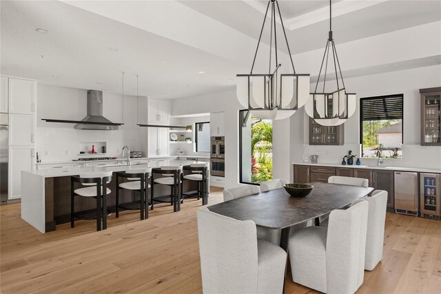 1624 Turnbull Crossings Dr, New Smyrna Beach, FL 32168 - dining space with healthy amount of natural light, a chandelier, light wood-style flooring, beverage cooler, and recessed lighting