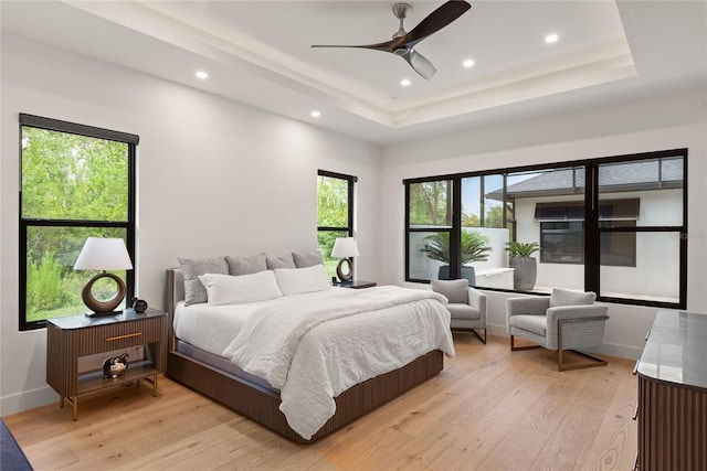 1624 Turnbull Crossings Dr, New Smyrna Beach, FL 32168 - bedroom with a tray ceiling, recessed lighting, light wood finished floors, and multiple windows