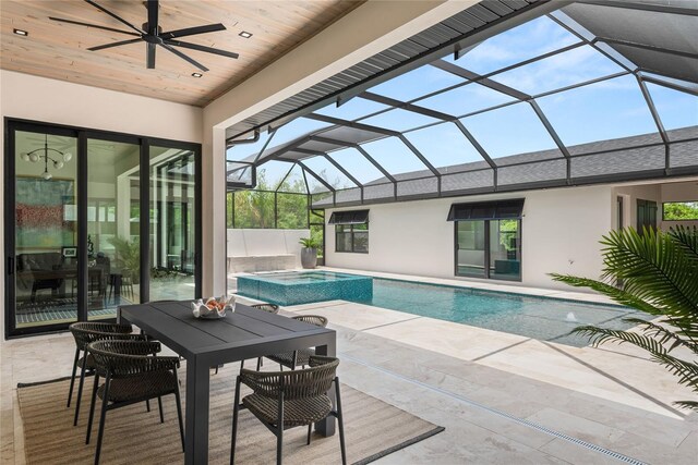 1624 Turnbull Crossings Dr, New Smyrna Beach, FL 32168 - outdoor pool with an in-ground hot tub, a ceiling fan, a patio area, and glass enclosure