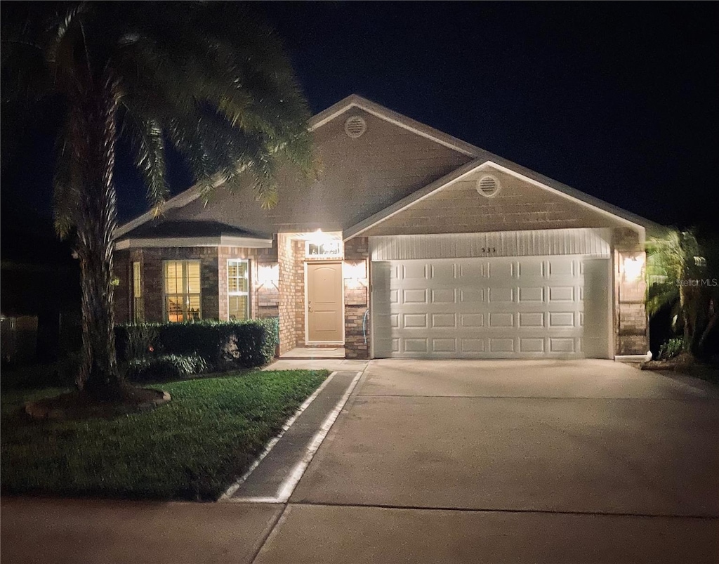 535 Coral Trace Blvd, Edgewater, FL 32132 - ranch-style home with concrete driveway and a garage