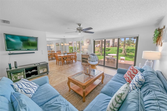 2961 Oceans Trce, Daytona Beach Shores, FL 32118 - living area featuring a ceiling fan, a textured ceiling, and tile patterned flooring