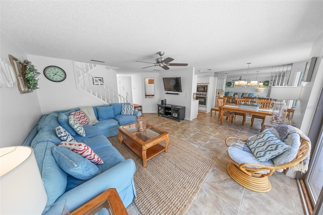 2961 Oceans Trce, Daytona Beach Shores, FL 32118 - living room featuring ceiling fan, stairway, a textured ceiling, and a chandelier