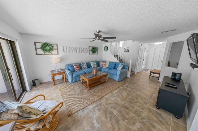 2961 Oceans Trce, Daytona Beach Shores, FL 32118 - living room with stairs, a textured ceiling, and a ceiling fan
