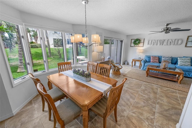 2961 Oceans Trce, Daytona Beach Shores, FL 32118 - dining space with healthy amount of natural light, a textured ceiling, a chandelier, ceiling fan, and baseboards