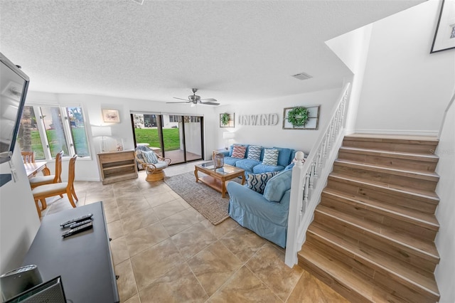 2961 Oceans Trce, Daytona Beach Shores, FL 32118 - living area with stairs, a ceiling fan, a textured ceiling, and baseboards