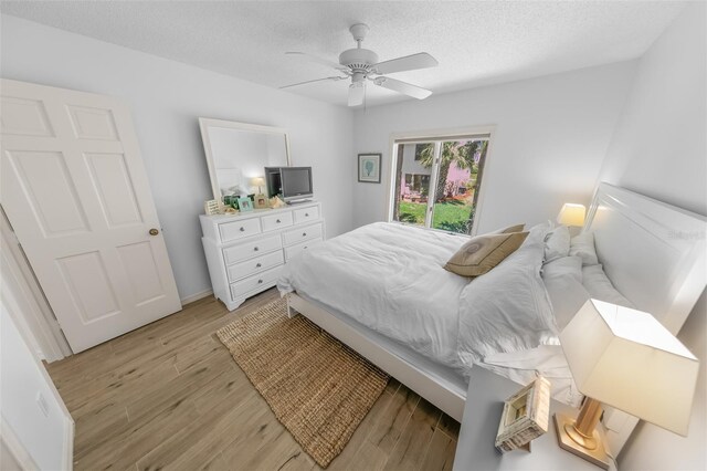 2961 Oceans Trce, Daytona Beach Shores, FL 32118 - bedroom featuring light wood finished floors, ceiling fan, and a textured ceiling