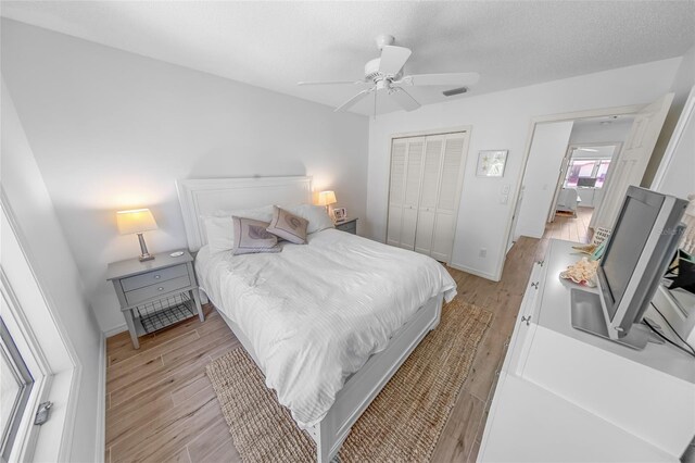 2961 Oceans Trce, Daytona Beach Shores, FL 32118 - bedroom with a closet, light wood-style floors, a ceiling fan, and baseboards