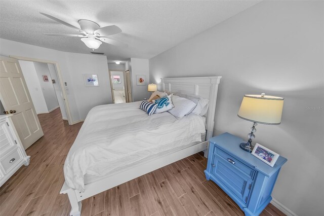 2961 Oceans Trce, Daytona Beach Shores, FL 32118 - bedroom with wood finished floors, a textured ceiling, a ceiling fan, and baseboards