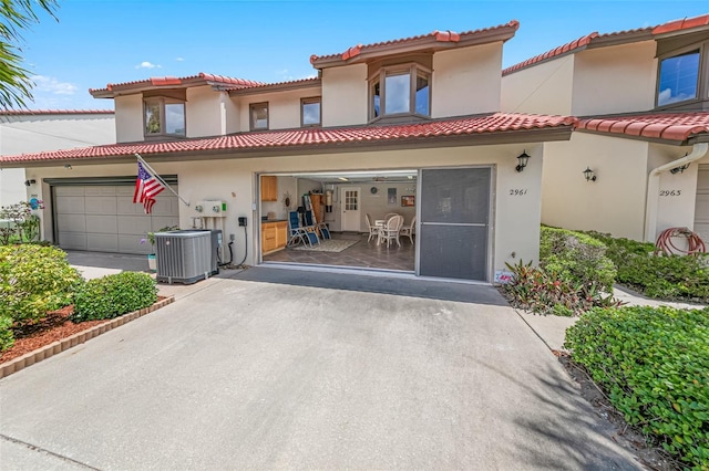 2961 Oceans Trce, Daytona Beach Shores, FL 32118 - view of front of property with driveway, stucco siding, central AC unit, and a tile roof