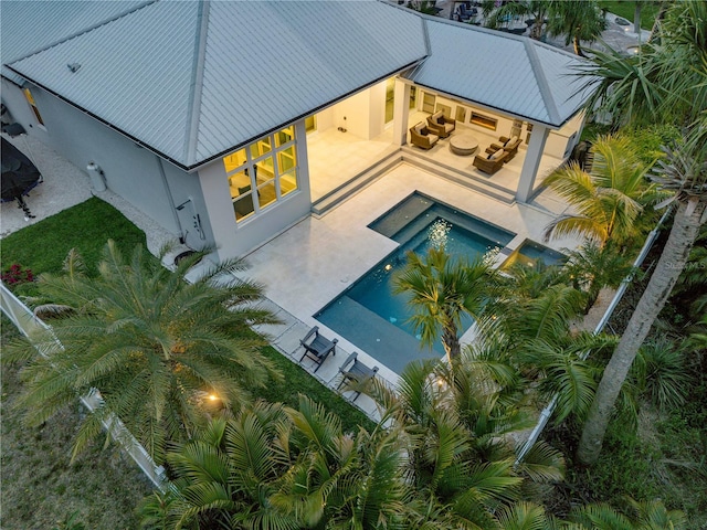 102 Inlet Shores Dr, New Smyrna Beach, FL 32168 - back of house with a patio, stucco siding, and an outdoor pool